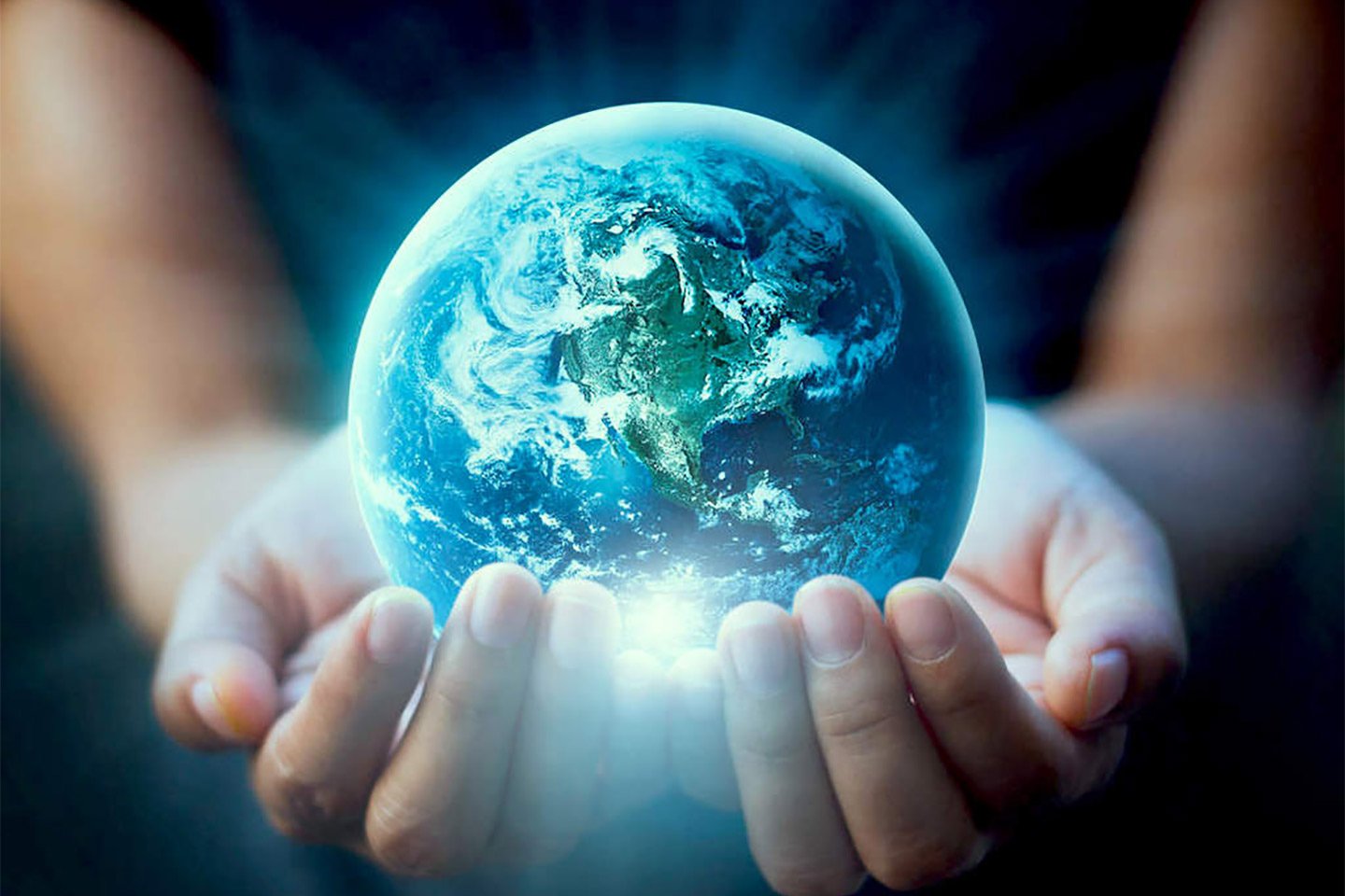 Earth held in hands glowing